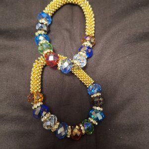 TWO  GOLD  AND COLOR STONE BRECELTS.